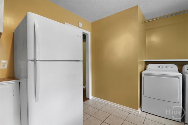 5012 Spartan Dr, Savannah, GA 31404 - washroom with light tile patterned flooring, washing machine and dryer, and a textured ceiling