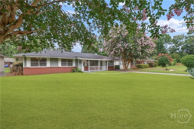 5012 Spartan Dr, Savannah, GA 31404 - ranch-style home with brick siding, a front lawn, covered porch, and driveway