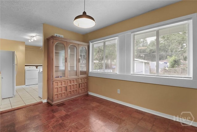 5012 Spartan Dr, Savannah, GA 31404 - unfurnished dining area featuring independent washer and dryer and a textured ceiling
