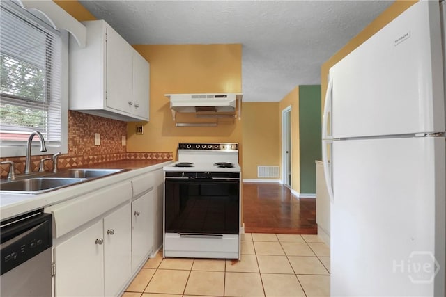 5012 Spartan Dr, Savannah, GA 31404 - kitchen with white appliances, extractor fan, white cabinetry, and backsplash