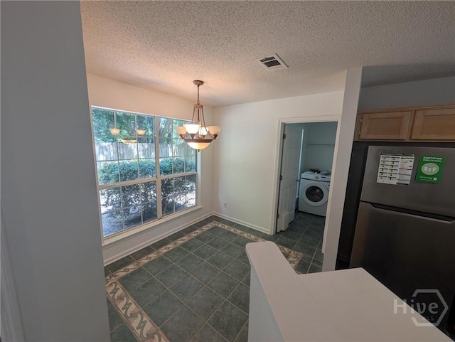 47 Rose Hill Dr, Savannah, GA 31419 - kitchen featuring washer / clothes dryer, freestanding refrigerator, a chandelier, a textured ceiling, and decorative light fixtures