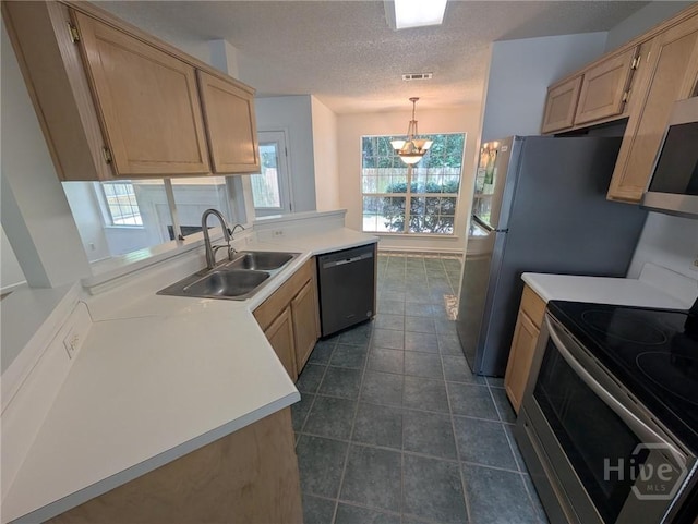 47 Rose Hill Dr, Savannah, GA 31419 - kitchen featuring appliances with stainless steel finishes, light brown cabinets, a peninsula, a chandelier, and a textured ceiling