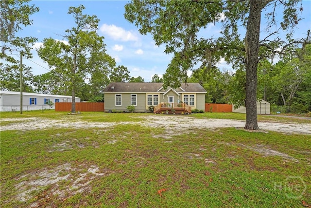 586 Church Cir, Jesup, GA 31545 - view of front facade with a storage shed and a wooden deck