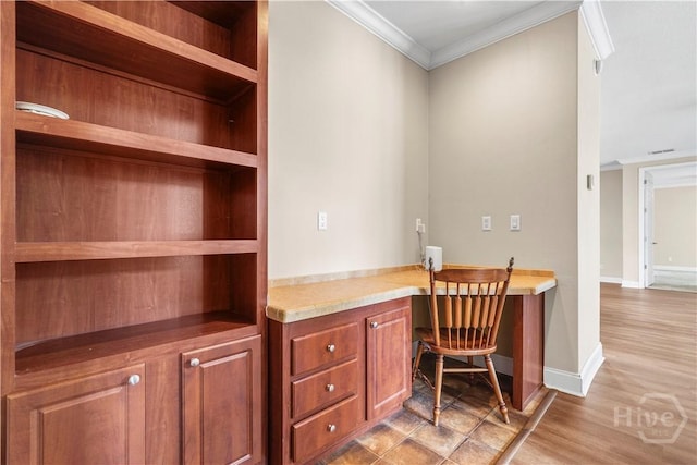 586 Church Cir, Jesup, GA 31545 - home office with crown molding, built in study area, and light wood-style floors