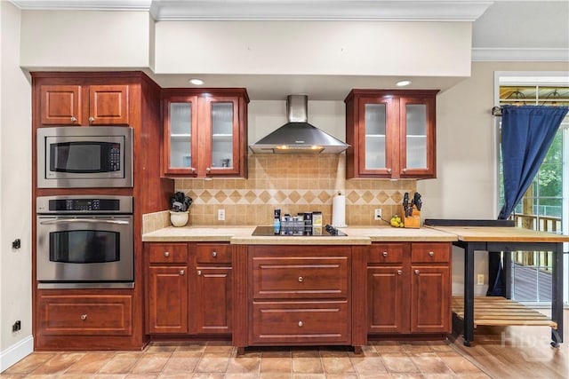 586 Church Cir, Jesup, GA 31545 - kitchen featuring appliances with stainless steel finishes, wall chimney range hood, ornamental molding, light countertops, and backsplash