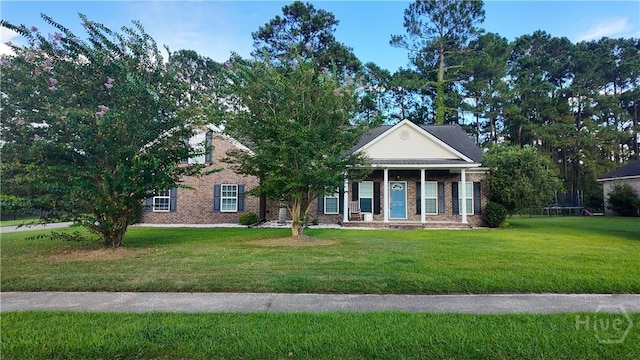 131 Brigham Dr, Richmond Hill, GA 31324 - view of front facade featuring a front lawn and brick siding