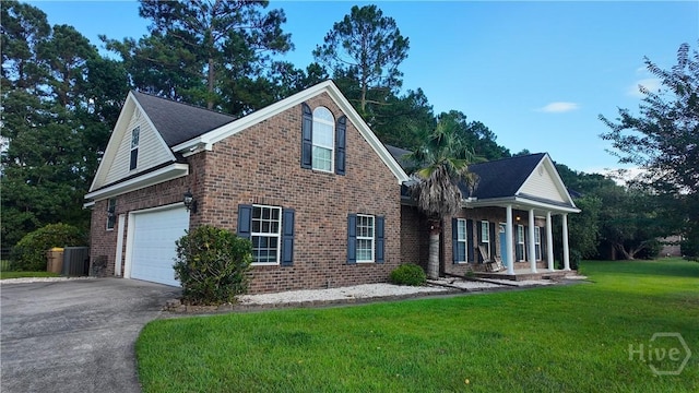 131 Brigham Dr, Richmond Hill, GA 31324 - traditional-style home with asphalt driveway, covered porch, and brick siding
