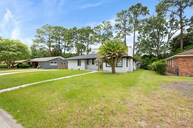 4611 Cumberland Dr, Savannah, GA 31405 - view of front of home with a chimney, driveway, and a front lawn