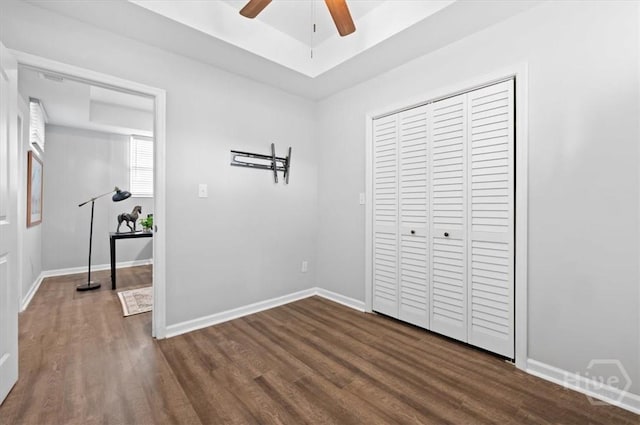4611 Cumberland Dr, Savannah, GA 31405 - unfurnished bedroom featuring dark wood-type flooring, a closet, a ceiling fan, and a raised ceiling