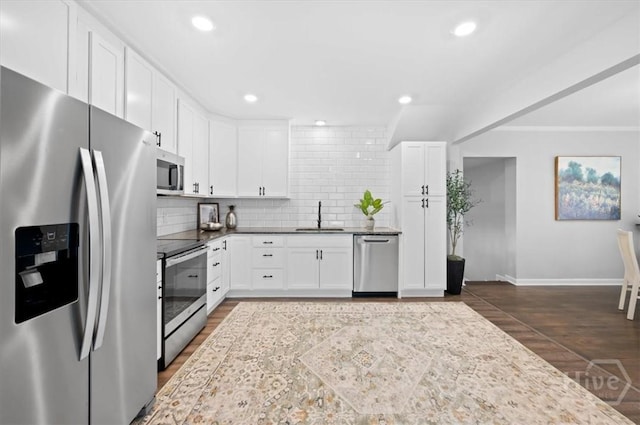 4611 Cumberland Dr, Savannah, GA 31405 - kitchen featuring stainless steel appliances, decorative backsplash, dark wood-style floors, white cabinetry, and recessed lighting