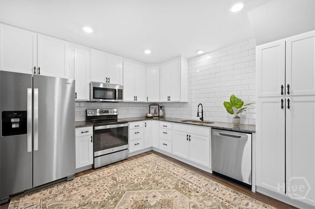 4611 Cumberland Dr, Savannah, GA 31405 - kitchen featuring appliances with stainless steel finishes, light wood-type flooring, white cabinets, backsplash, and recessed lighting