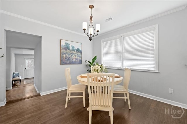 4611 Cumberland Dr, Savannah, GA 31405 - dining space with dark wood finished floors, ornamental molding, and a chandelier