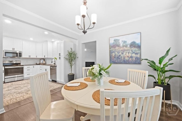 4611 Cumberland Dr, Savannah, GA 31405 - dining space featuring ornamental molding, dark wood-type flooring, a chandelier, and recessed lighting