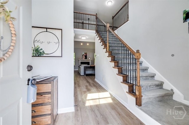 172 Green Paddock Cir, Guyton, GA 31312 - entryway featuring stairway, wood finished floors, and a towering ceiling