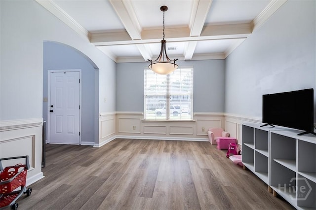 172 Green Paddock Cir, Guyton, GA 31312 - unfurnished dining area with beamed ceiling, coffered ceiling, wood finished floors, a chandelier, and a wainscoted wall