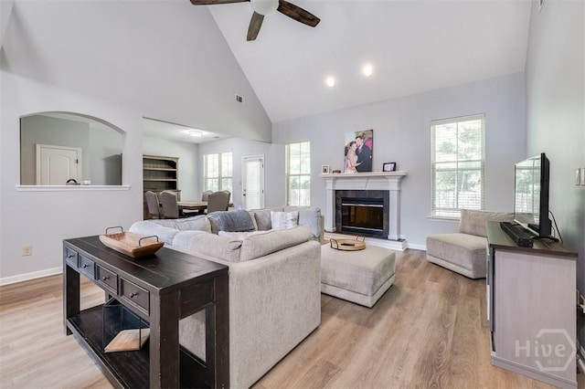 172 Green Paddock Cir, Guyton, GA 31312 - living area with a ceiling fan, high vaulted ceiling, light wood-type flooring, and a glass covered fireplace
