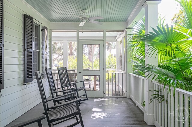 63 Magnolia Ln, Richmond Hill, GA 31324 - sunroom featuring a ceiling fan, plenty of natural light, wood finished floors, crown molding, and wooden walls