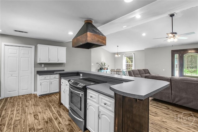 324 Elm St, Eden, GA 31307 - kitchen with stainless steel range with electric cooktop, dark countertops, ceiling fan, white cabinetry, and wood finished floors