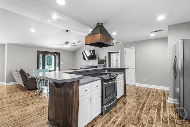 324 Elm St, Eden, GA 31307 - kitchen featuring appliances with stainless steel finishes, open floor plan, dark countertops, white cabinets, and light wood finished floors