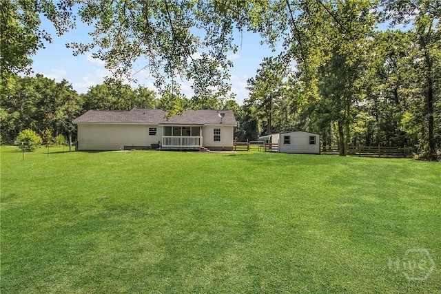324 Elm St, Eden, GA 31307 - back of house featuring a fenced backyard, a wooden deck, and a shed