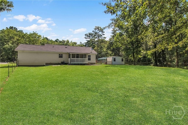 324 Elm St, Eden, GA 31307 - back of property with a yard, a shed, and view of wooded area