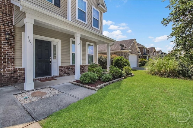 129 Winslow Cir, Savannah, GA 31407 - doorway to property with brick siding, covered porch, and a lawn