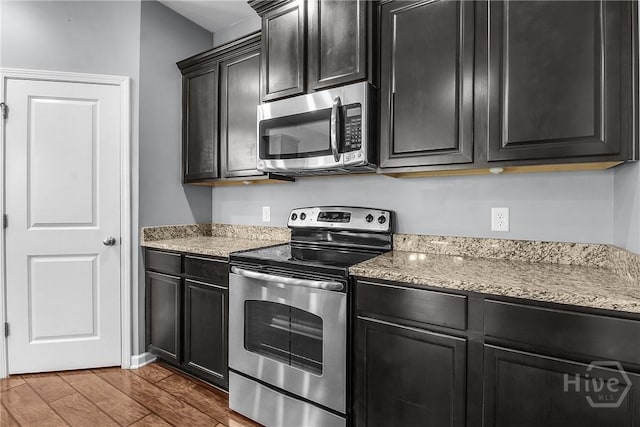 129 Winslow Cir, Savannah, GA 31407 - kitchen featuring appliances with stainless steel finishes, light stone counters, wood finished floors, and dark cabinets