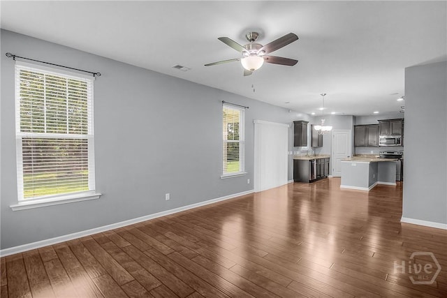129 Winslow Cir, Savannah, GA 31407 - unfurnished living room with a ceiling fan, dark wood-style floors, a chandelier, and recessed lighting