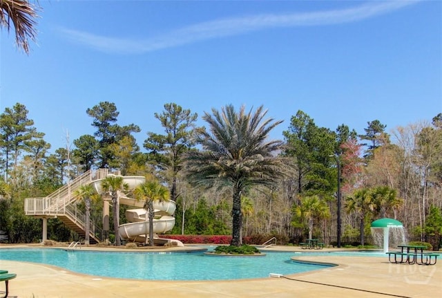 129 Winslow Cir, Savannah, GA 31407 - community pool featuring a water slide, a patio area, and stairs