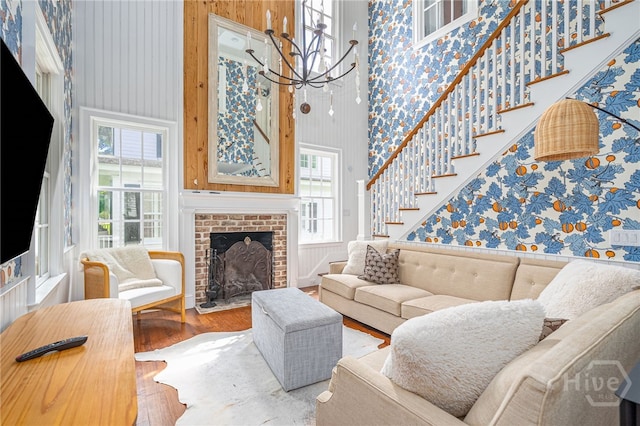 46 Cherry Laurel Ln, Richmond Hill, GA 31324 - living area with wallpapered walls, wood finished floors, plenty of natural light, stairway, and a high ceiling