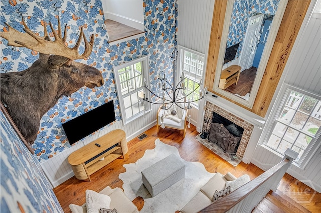 46 Cherry Laurel Ln, Richmond Hill, GA 31324 - living area with plenty of natural light, wallpapered walls, a fireplace with flush hearth, and wood finished floors