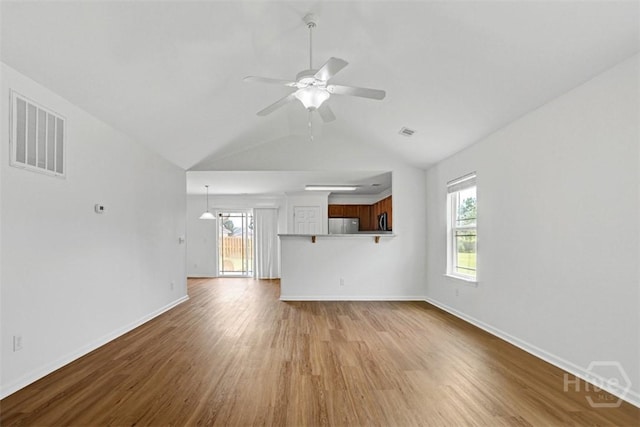 93 Lake Shore Blvd, Port Wentworth, GA 31407 - unfurnished living room with wood finished floors, ceiling fan, and vaulted ceiling