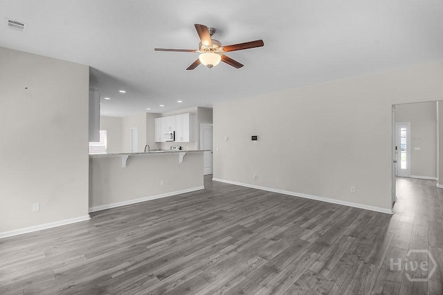 105 Telford St, Savannah, GA 31407 - unfurnished living room with ceiling fan, dark wood finished floors, and recessed lighting
