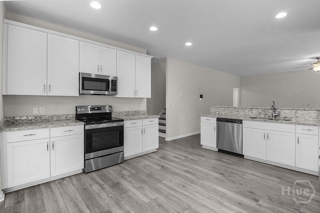 105 Telford St, Savannah, GA 31407 - kitchen with stainless steel appliances, light wood finished floors, white cabinets, a ceiling fan, and recessed lighting
