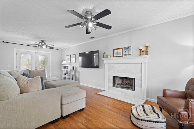 139 Marsh Edge Ln, Savannah, GA 31419 - living area with a textured ceiling, ceiling fan, wood finished floors, a tile fireplace, and crown molding