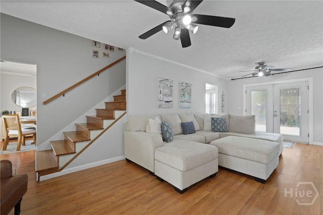 139 Marsh Edge Ln, Savannah, GA 31419 - living room featuring a ceiling fan, stairs, light wood-style flooring, a textured ceiling, and ornamental molding