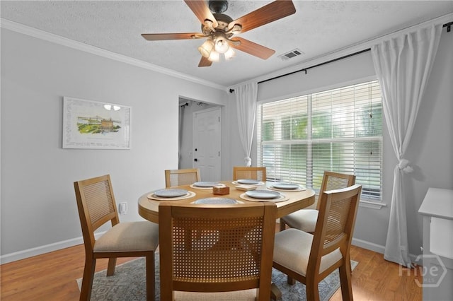 139 Marsh Edge Ln, Savannah, GA 31419 - dining area featuring light wood-type flooring, ceiling fan, ornamental molding, and a textured ceiling