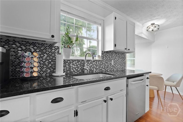 139 Marsh Edge Ln, Savannah, GA 31419 - kitchen with dishwasher, white cabinetry, a textured ceiling, dark stone counters, and tasteful backsplash