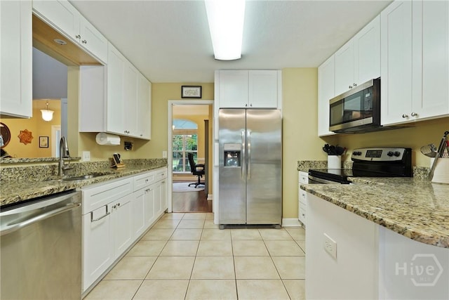 27 Heron View Ct, Richmond Hill, GA 31324 - kitchen featuring stainless steel appliances, white cabinets, light tile patterned floors, and light stone counters