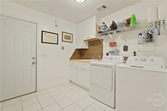 27 Heron View Ct, Richmond Hill, GA 31324 - washroom with independent washer and dryer, light tile patterned flooring, and cabinet space