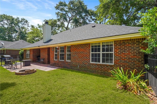 27 Heron View Ct, Richmond Hill, GA 31324 - rear view of property featuring a patio area, a fire pit, a chimney, and brick siding