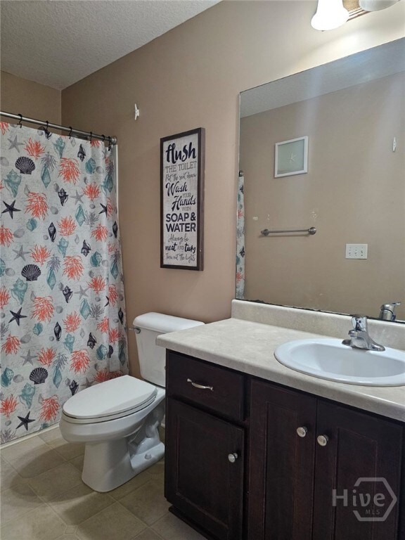 401 Barry Mccaffrey Blvd Unit E2, Hinesville, GA 31313 - full bathroom featuring vanity, a textured ceiling, tile patterned floors, and a shower with curtain