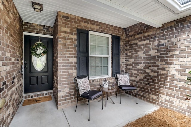 160 Wild Honey Ct, Richmond Hill, GA 31324 - property entrance featuring brick siding and a porch
