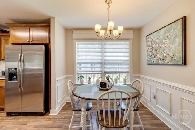 160 Wild Honey Ct, Richmond Hill, GA 31324 - dining space with a decorative wall, wainscoting, wood finished floors, and a chandelier