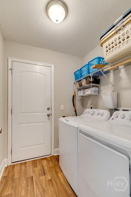 160 Wild Honey Ct, Richmond Hill, GA 31324 - washroom with separate washer and dryer, light wood-style flooring, and a textured ceiling