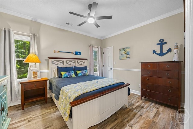 139 Mingarry Dr, Richmond Hill, GA 31324 - bedroom with wood finished floors, crown molding, and a ceiling fan
