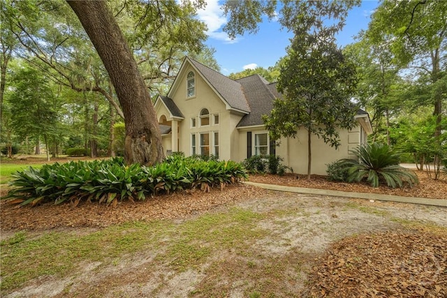 139 Mingarry Dr, Richmond Hill, GA 31324 - view of front of home featuring stucco siding and roof with shingles