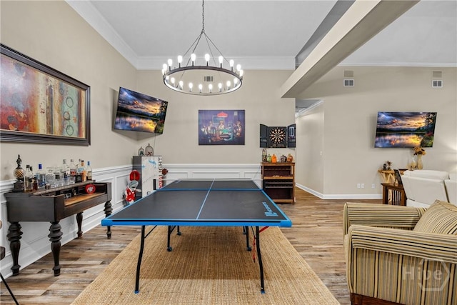 139 Mingarry Dr, Richmond Hill, GA 31324 - game room with wood finished floors, ornamental molding, a chandelier, and a wainscoted wall