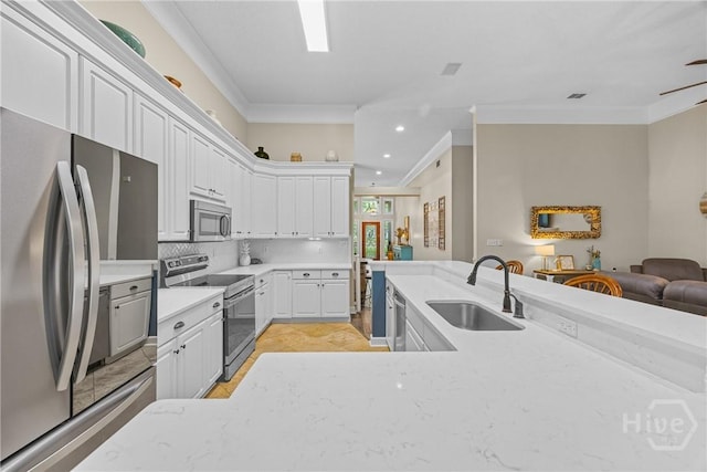 139 Mingarry Dr, Richmond Hill, GA 31324 - kitchen with stainless steel appliances, ornamental molding, tasteful backsplash, recessed lighting, and open floor plan