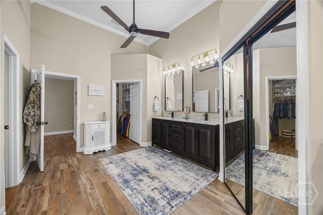 139 Mingarry Dr, Richmond Hill, GA 31324 - full bathroom featuring crown molding, double vanity, ceiling fan, a walk in closet, and a high ceiling